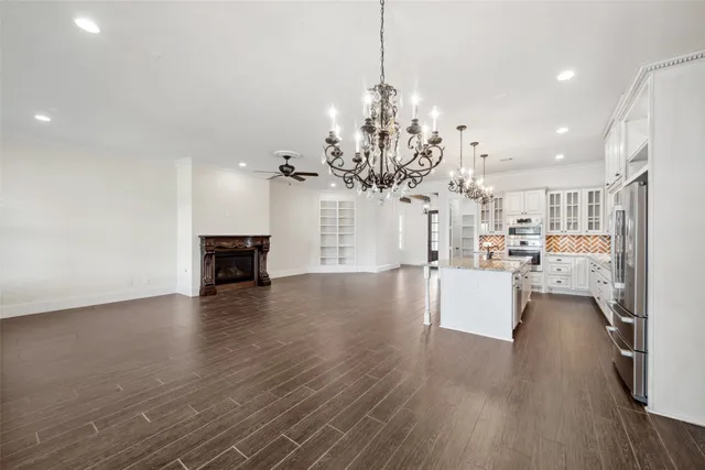 a view of a room with wooden floor and kitchen