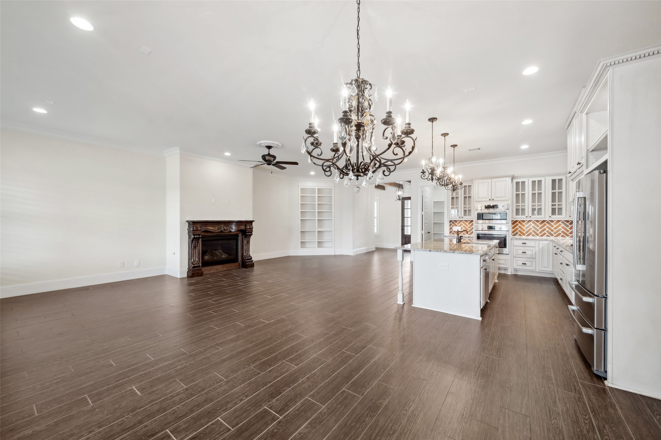 2149 Rope Maker Road Conroe, TX 77384 - Photo 6 of 45 a view of a room with wooden floor and kitchen