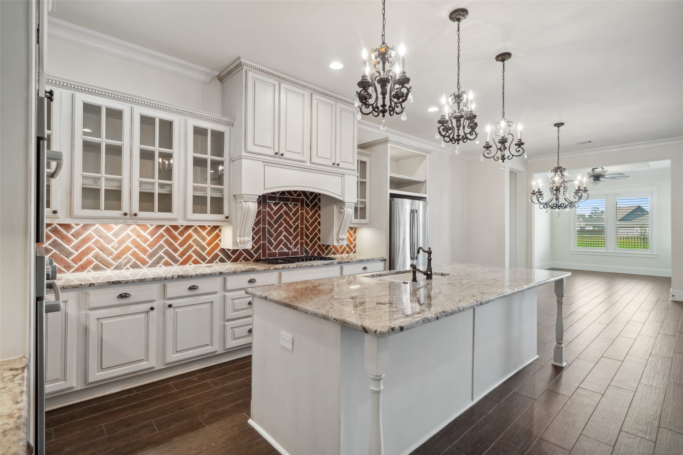 2149 Rope Maker Road Conroe, TX 77384 - Photo 7 of 45 a kitchen with stainless steel appliances granite countertop a sink dishwasher a stove refrigerator and cabinets with wooden floor