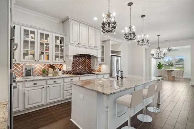 a kitchen with center island a sink cabinets and wooden floor