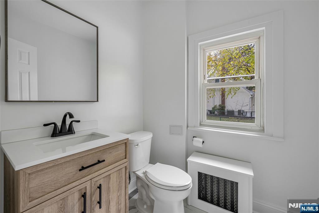 684 Closter Dock Road Closter, NJ 07624 - Photo 16 of 30 a bathroom with a toilet sink and mirror