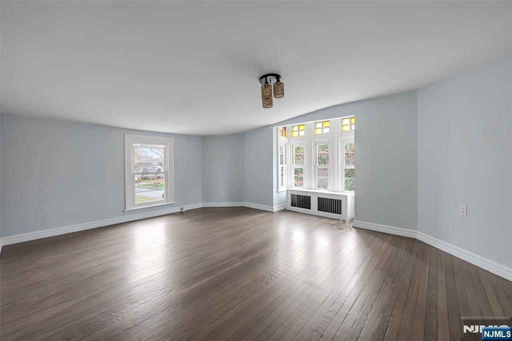 684 Closter Dock Road Closter, NJ 07624 - Photo 19 of 30 an empty room with wooden floor and windows