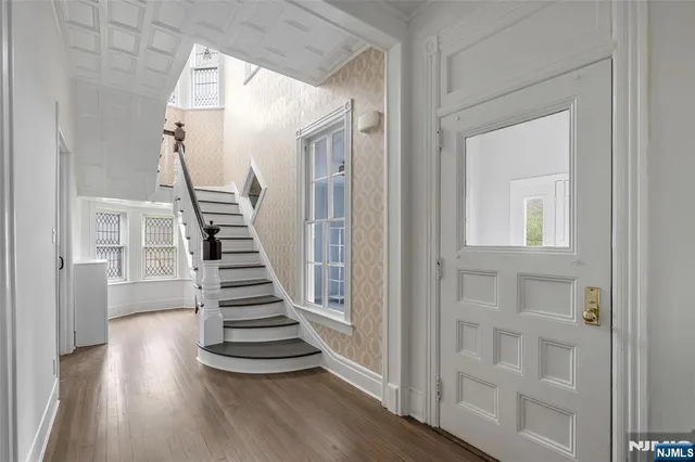 a view of a hallway with wooden floor and entryway