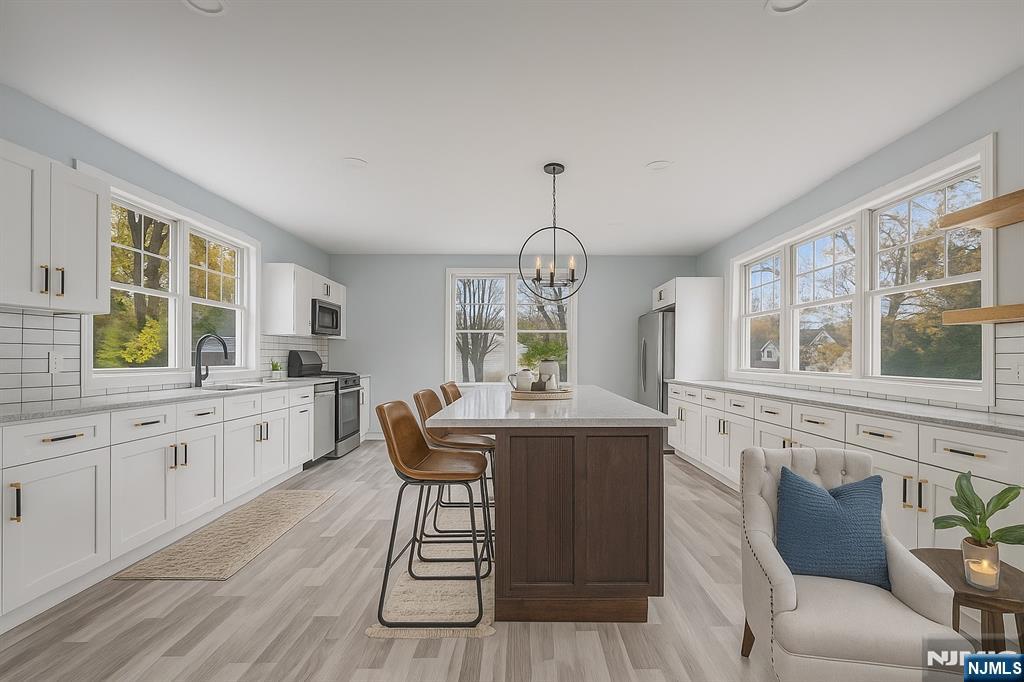684 Closter Dock Road Closter, NJ 07624 - Photo 6 of 30 a view of a dining room with furniture window and wooden floor
