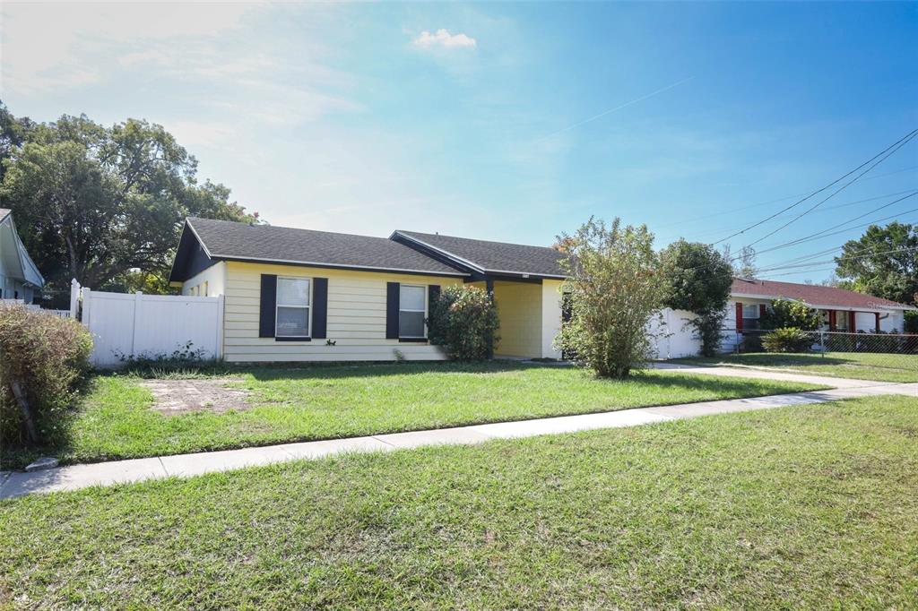 4516 Rundle Road Orlando, FL 32810 - Photo 1 of 1 a front view of a house with a yard and garage