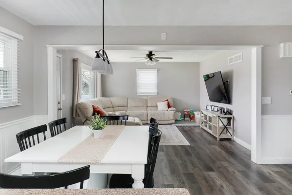 a living room with furniture a rug and a flat screen tv