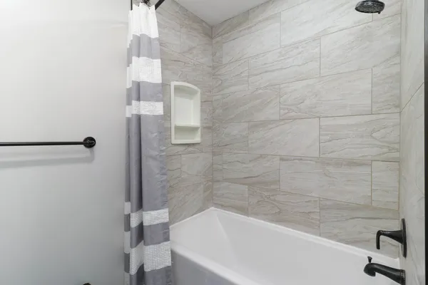 a bathroom with a bathtub and a shower