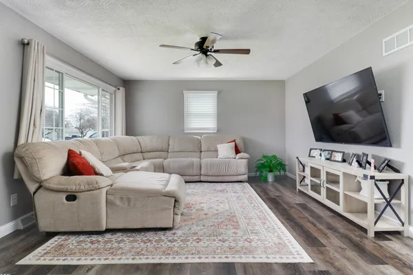 a living room with furniture and a flat screen tv