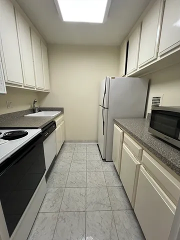 a kitchen with a sink and a refrigerator