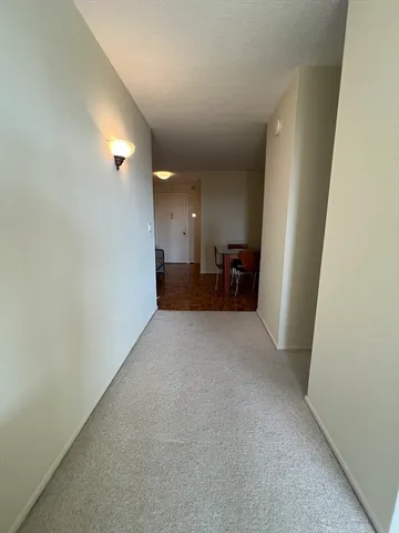 an empty room with furniture and a window