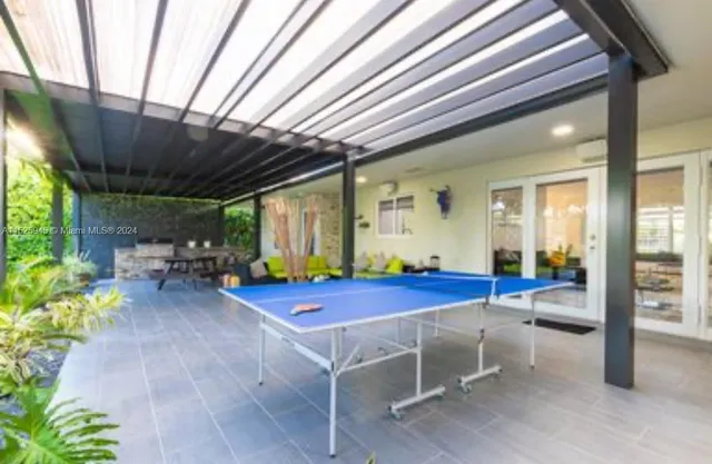 a view of a patio with table and chairs and potted plants