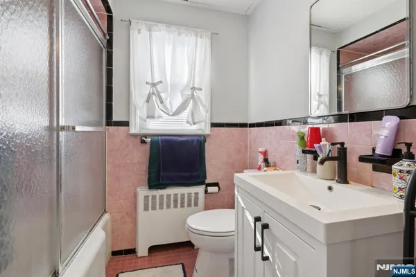 a bathroom with a sink a toilet and a mirror