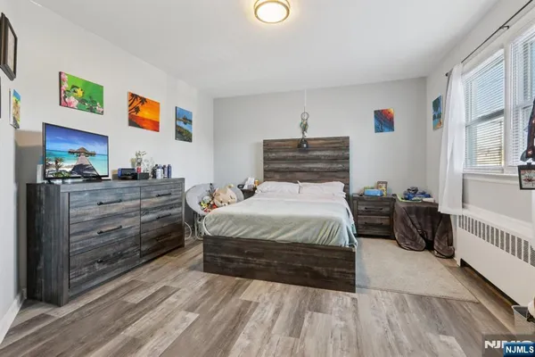 a spacious bedroom with a bed and a cabinets