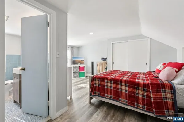 a bedroom with a bed and a closet