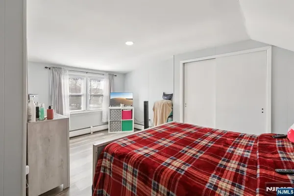 a bedroom with a bed and a large window