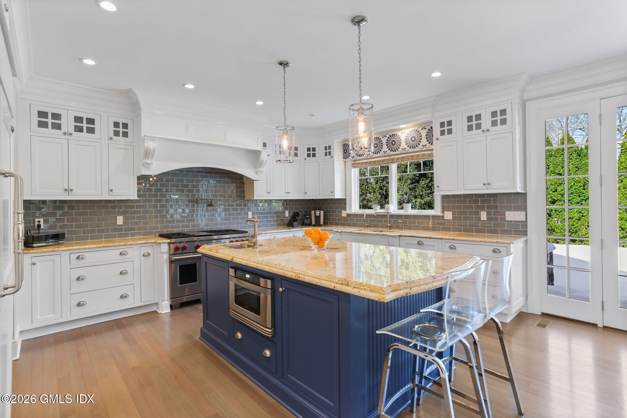 1 Bramble Lane Riverside, CT 06878 - Photo 12 of 42 a kitchen with a stove a sink a center island and wooden floor