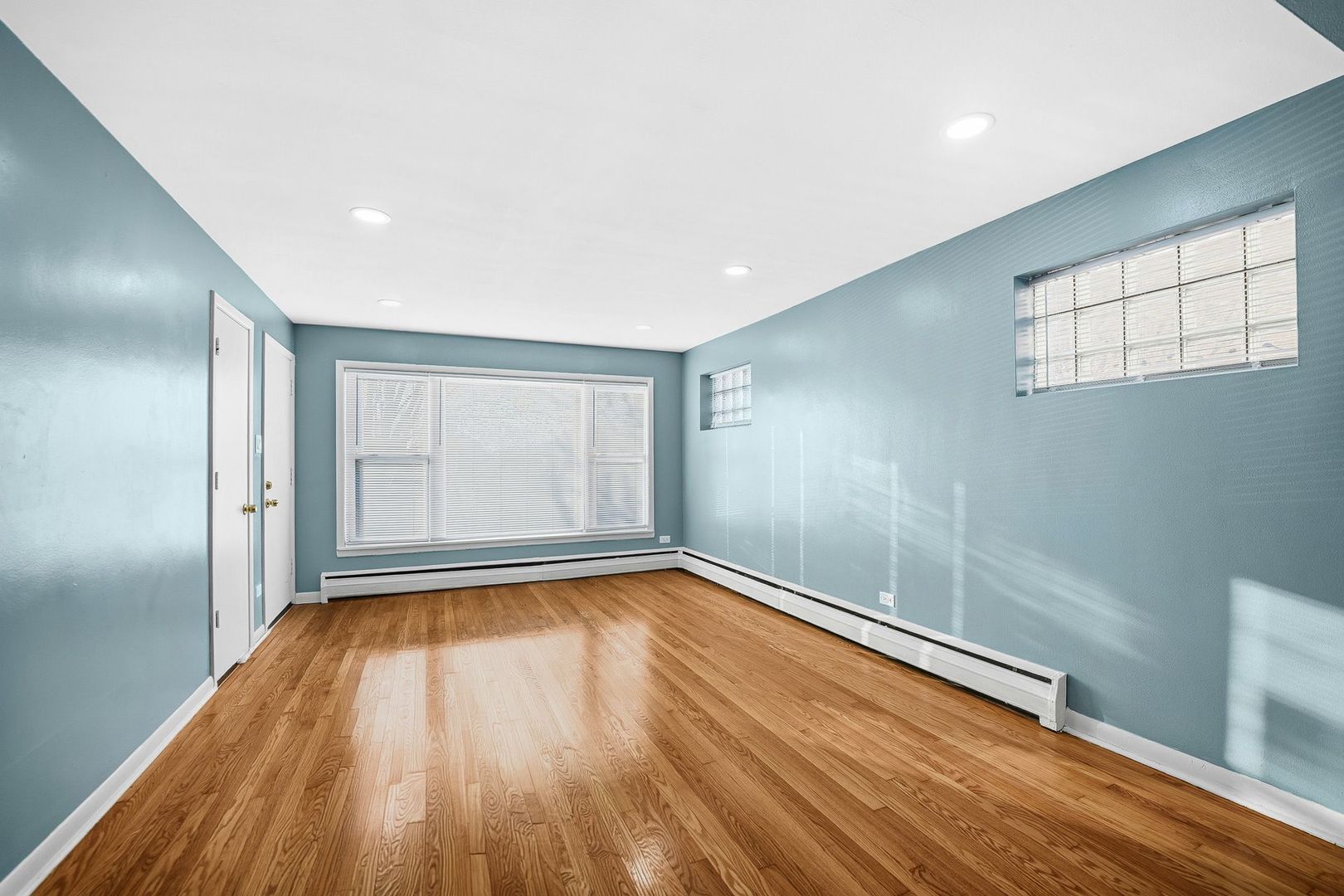 9209 South State Street Chicago, IL 60619 - Photo 2 of 20 a view of room with window and wooden floor