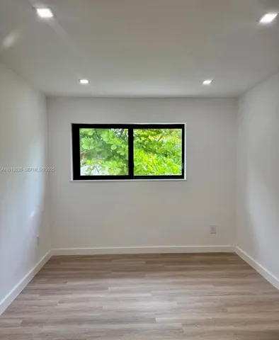 a view of a room with wooden floor and bench