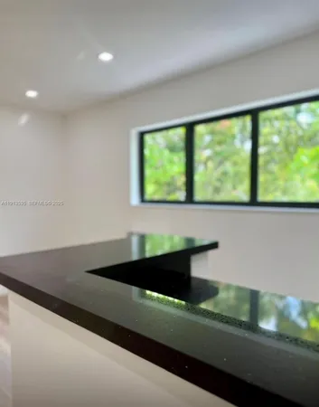 a view of a kitchen with a sink a refrigerator and window