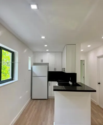 a view of room with wooden floor