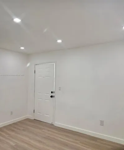 a kitchen with stainless steel appliances granite countertop a sink and a large window