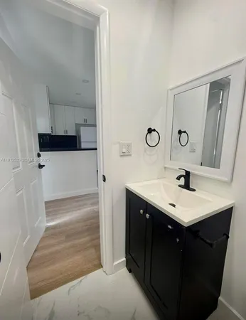 a white toilet sitting next to a shower