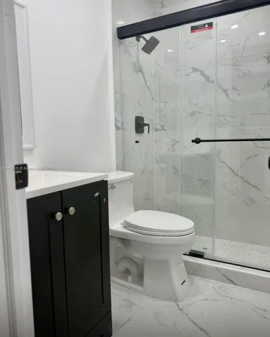 a bathroom with a shower and a toilet