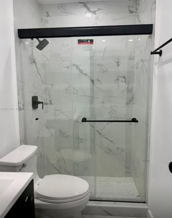 a bathroom with a sink vanity and toilet