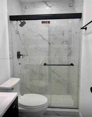 a bathroom with a sink vanity and toilet