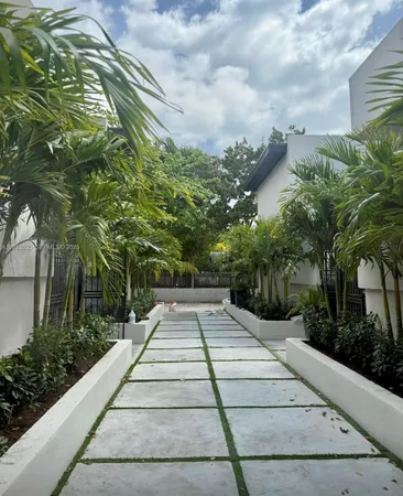a front view of a house with plants