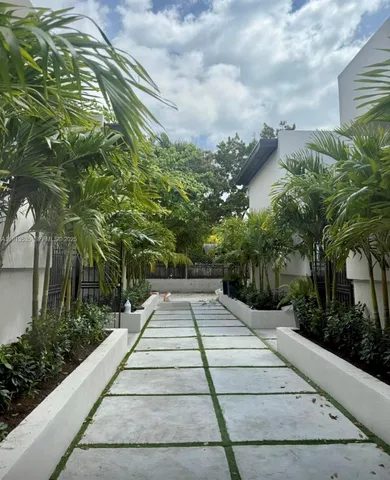 a front view of a house with plants