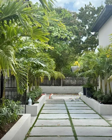 a view of a house with a plants and a tree
