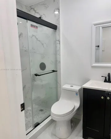 a bathroom with a sink vanity and toilet