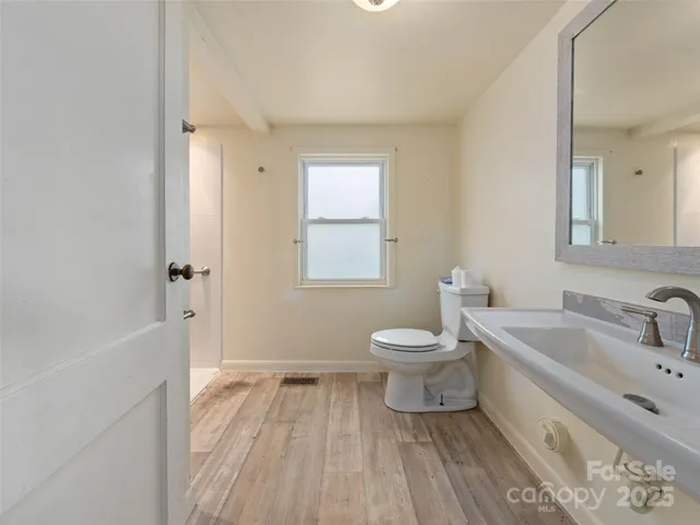 a spacious bathroom with a toilet sink and a bathtub