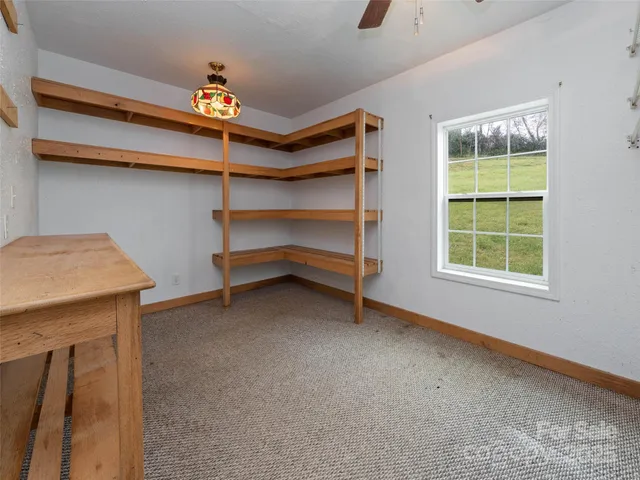 a view of room with window and cabinet