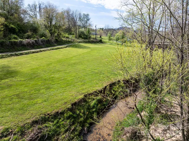 a wooden bench sitting in the middle of a field