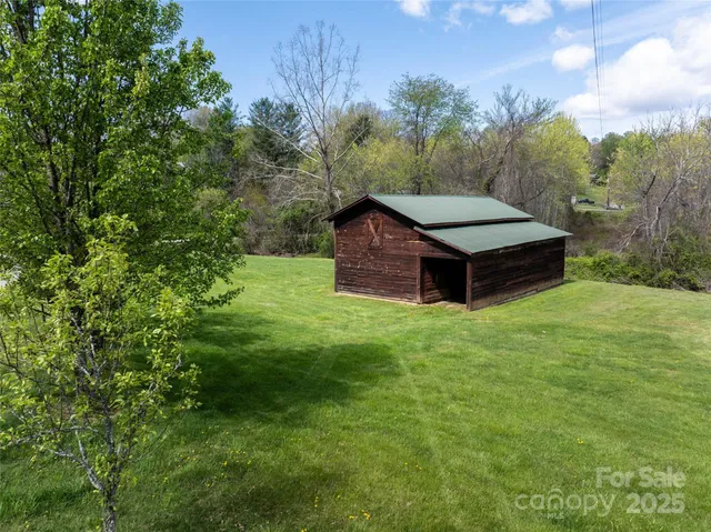 a view of a backyard with wooden fence
