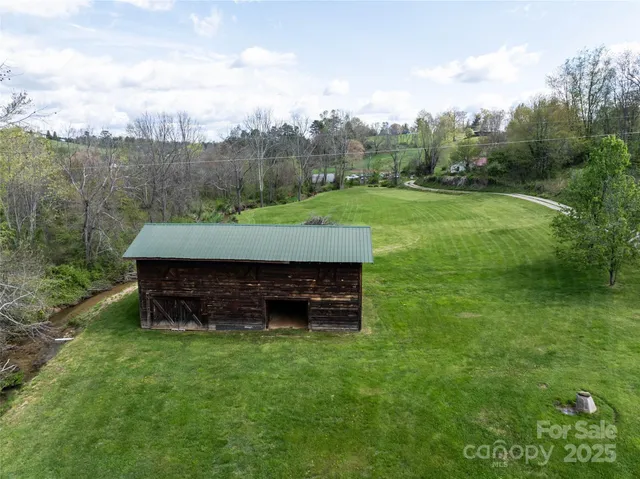 an aerial view of a residential houses with yard