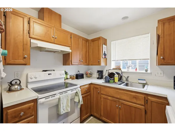 a kitchen with a sink cabinets and a refrigerator