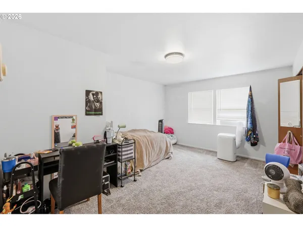 a bedroom with a bed and a table