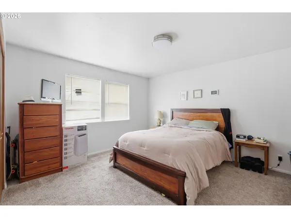 a bedroom with a bed and a dresser