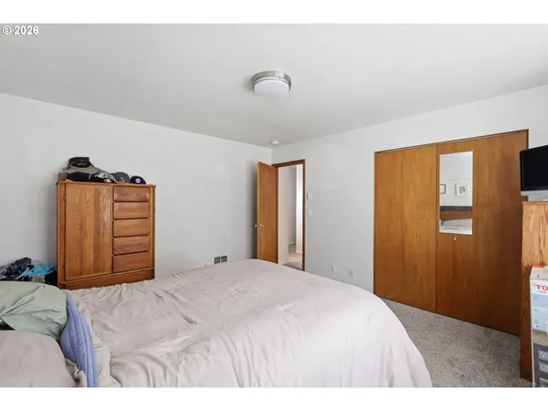 a bedroom with a large bed and a chandelier