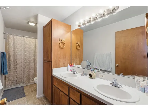a bathroom with a shower and a mirror