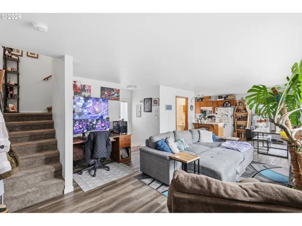 a living room with furniture and a potted plant