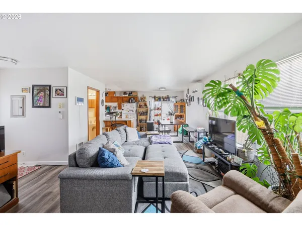 a living room with furniture and a wooden floor