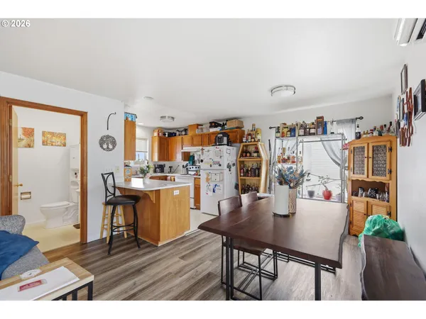 a kitchen with cabinets and wooden floor