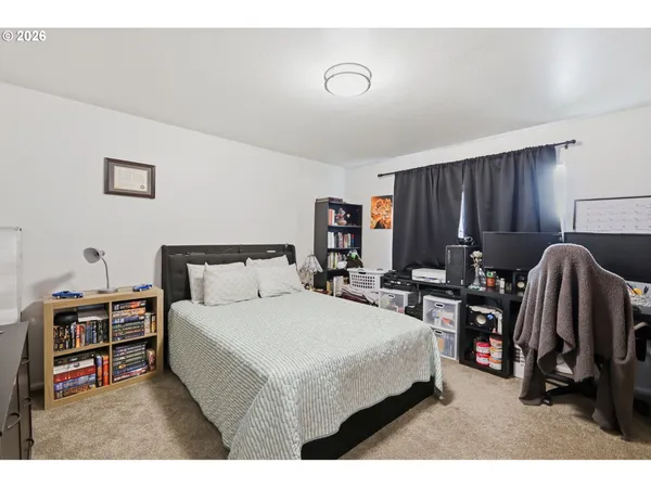 a bedroom with a bed and a dresser