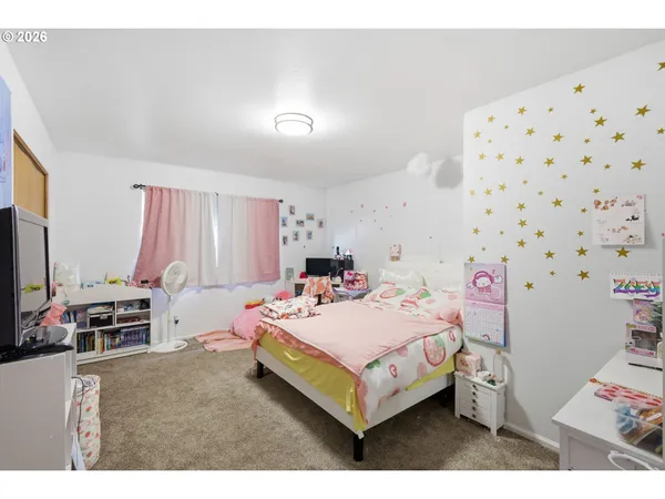 a bedroom with a bed and a flat screen tv