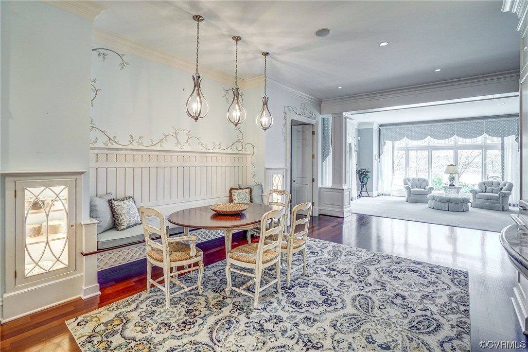 501 Rivergate Drive Henrico, VA 23238 - Photo 13 of 50 a dining room with wooden floor a chandelier a wooden table and chairs
