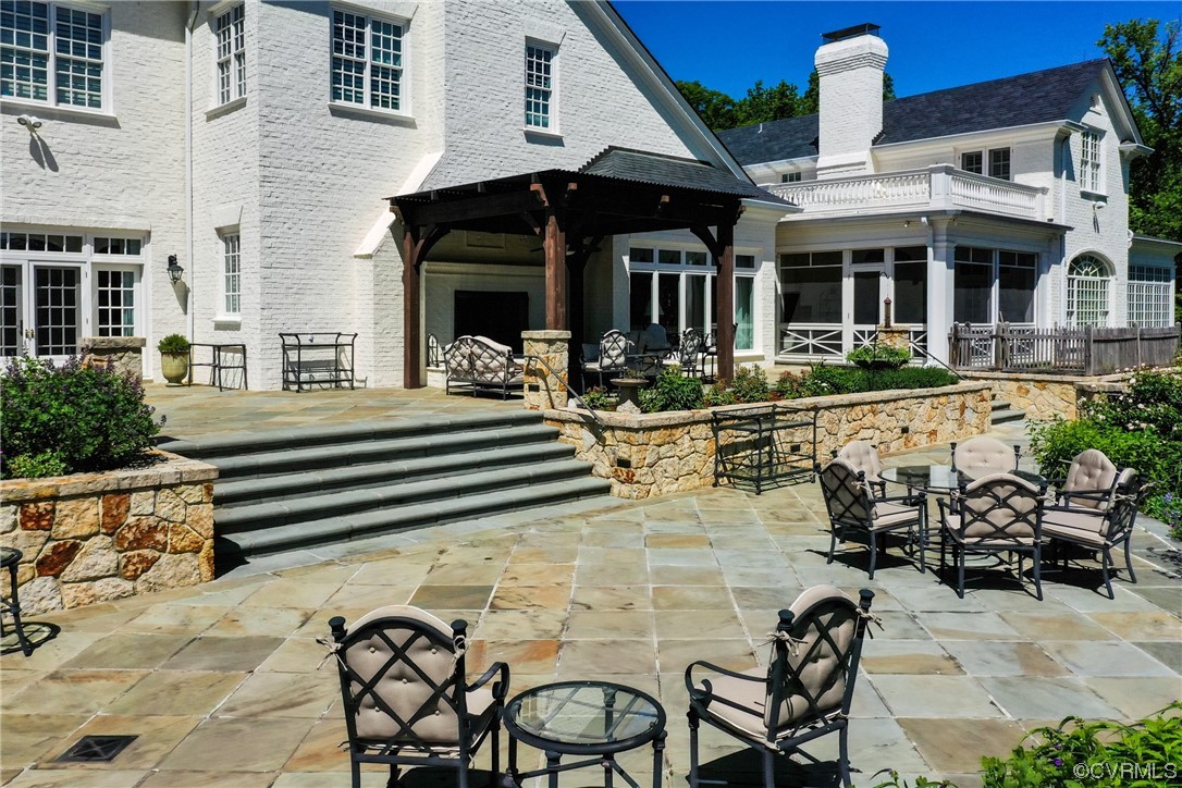 501 Rivergate Drive Henrico, VA 23238 - Photo 47 of 50 a view of a patio with table and chairs potted plants and a floor to ceiling window